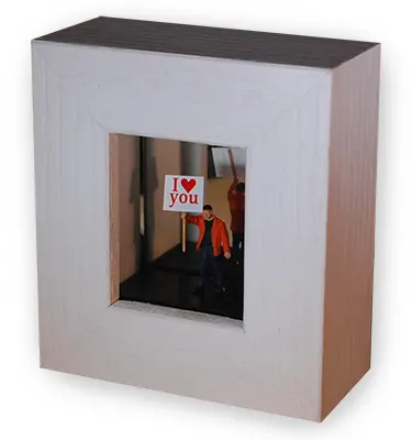 Small box frame with man holding a sign saying "I love you"